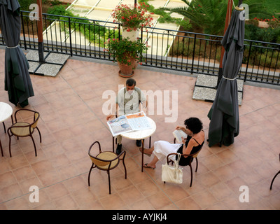 Palermo Sicily Italy Genoardo Park Hotel Reading Newspaper on Terrace Couple Sitting at Table Stock Photo