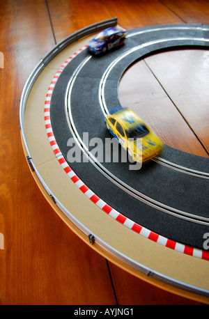 scalextric slotracing car track on timber floor Stock Photo