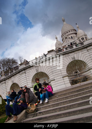 People on the steps of the famous Sacre Coeur church in Montmartre Paris France Stock Photo
