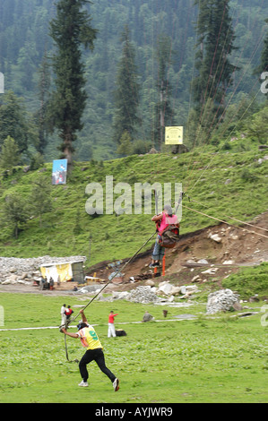 India local tourists enjoying a day of sport and recreation on the mountain side with gliders Stock Photo