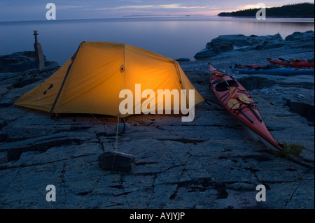 Tent and kayak in evening on remote stretch of Lake Superior Stock Photo