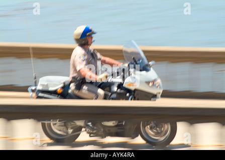 Motorcycling policeman traveling across Bixby bridge on Highway 1 pacific coast Hwy near Monterey California Stock Photo