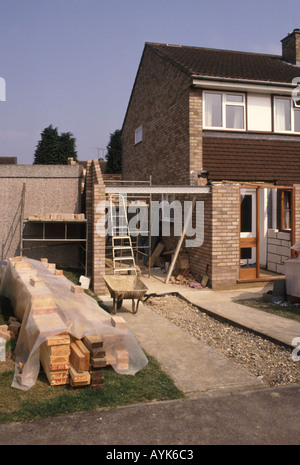 Domestic house side garage extension entrance porch alterations in progress with timber stack for first floor bedroom joists Stock Photo