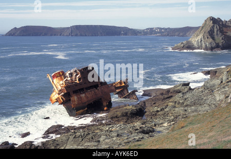 South Devon rocky coastline & rust on shipwreck of cargo ship MV Demetrios wrecked on rocks in coastal landscape & seascape at Prawle Point England UK Stock Photo