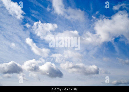 Horizontal view of cumulus and cirrus cloud formations against a bright blue sky Stock Photo