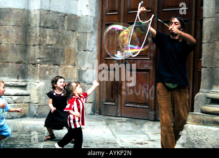 Street entertainer blows bubbles for children in Bilbao Spain Stock Photo