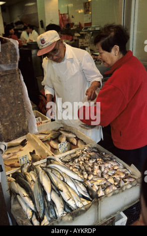 Female asian shopper buying fish at a fish store in Chinatown San Francisco USA October 2004 Stock Photo