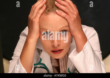 tired young female doctor. Stock Photo