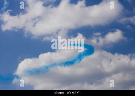 Red Arrow forming blue curve against white cloud Stock Photo