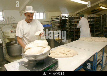 kneading dough to make bread in a bakery Stock Photo