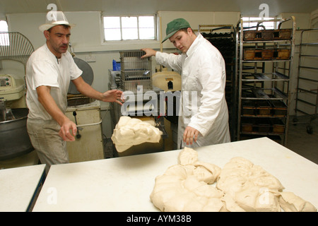 kneading dough to make bread in a bakery Stock Photo