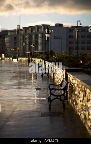 Seaside promenade caught in the early morning light following a rain shower Stock Photo