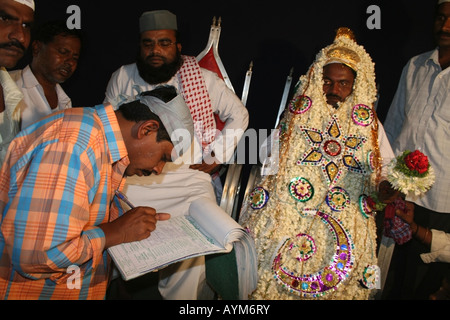 Muslim groom signs Nikaahnaama ( marriage certificate ...