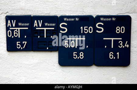 Cryptic signs on a wall in Berlin, Dark blue on white. Stock Photo