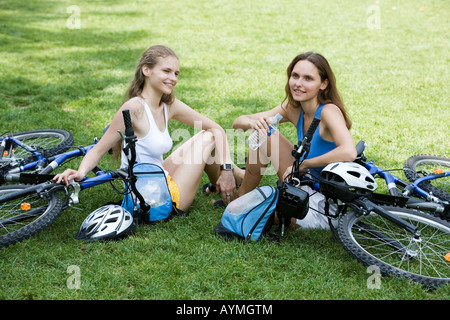 two young beautiful woman are visiting paris in summer with bicycle Stock Photo