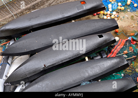 Close up of fishing currachs, canvas and tar-covered rowing boats dunquin pier dingle peninsula kerry ireland Stock Photo