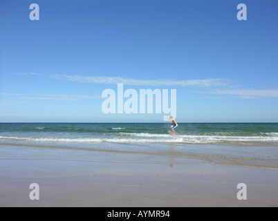 Teen boy on skimboard Stock Photo