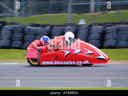 Motorbike and Sidecar at Wirral 100 Motor Club Race Meeting at Oulton Park Motor Racing Circuit Cheshire England Stock Photo