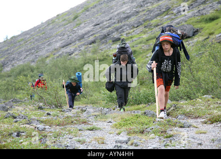 Children tourist group trekking up to the mountain pass Yum'egor in the Khibiny mountains of the Kola Peninsula, Russia Stock Photo