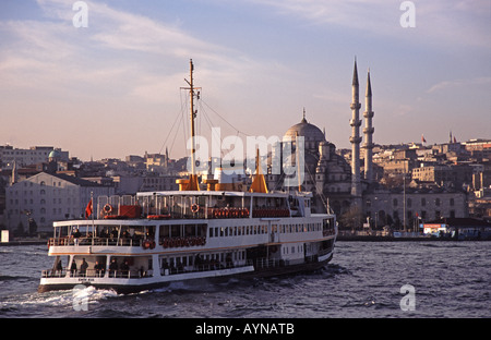 ISTANBUL, TURKEY. A Bosphorus ferry on the Golden Horn with the Yeni Camii behind. Stock Photo