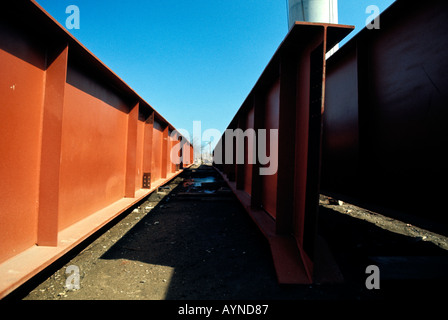 Steel girder staged and waiting to be put in place for an overhead highway construction project Stock Photo