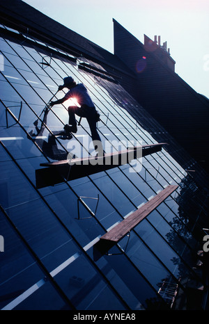 Workman installing thermal glass roof on a new office building Stock Photo