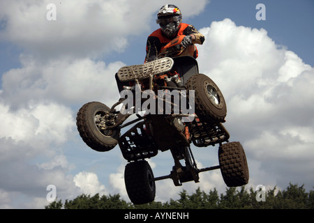 A quad racer clears a tabletop jump at Mildenhall. Stock Photo