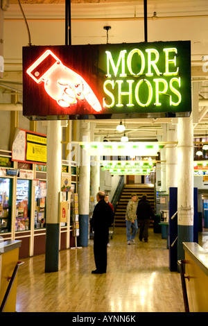 Seattlle Washington State USA shoppers at Pike Place Market in ground floor and neon sign directing shoppers Stock Photo