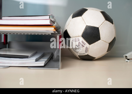 Football on the desktop besides some documents Stock Photo