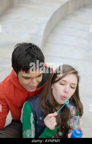 Young couple blowing soap bubbles Stock Photo