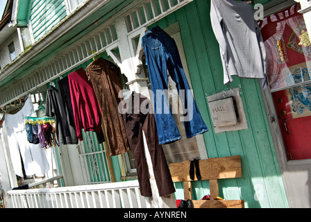 Laundry drying in the sun in front of an old house in the downtown eastside heritage district of Strathcona Stock Photo