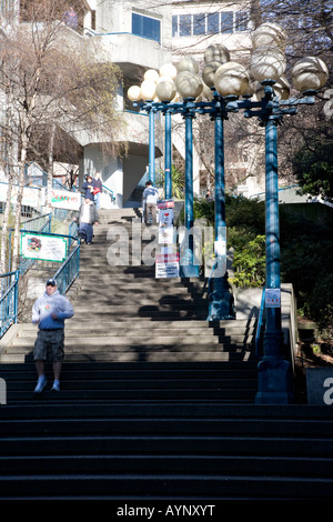 Man walking on staircase outside of a building between waterfront and downtown area, Seattle, USA Stock Photo