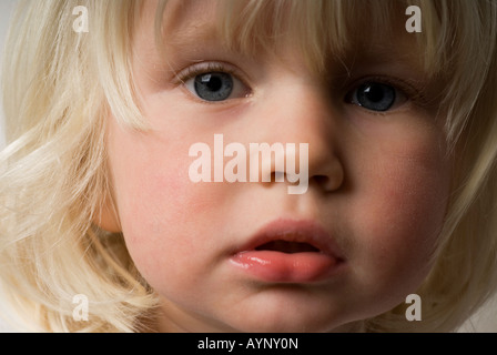 Stock photo of a close up shot of a blue eyed blond haired two year old girl Stock Photo