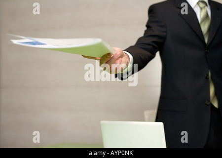 Businessman handing over documents Stock Photo