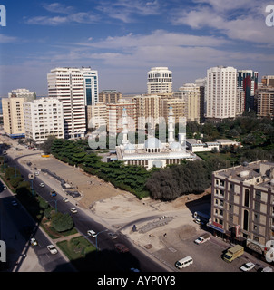 UAE Abu Dhabi Middle East Gulf State Elevated view over mosque surrounded by trees and high rise buildings beside a road. Stock Photo
