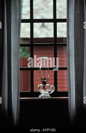 Kerosene lamp in window antique house Stock Photo