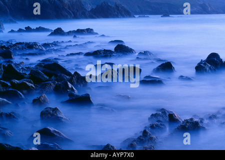 waves breaking around rocks on the Brittany coast near the Point du Raz Bretagne France Stock Photo