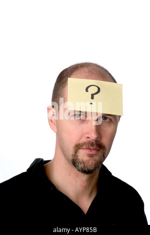 man with post it note on his head illustrating that he is thinking thought idea question answer quiz think mind brain confusio Stock Photo