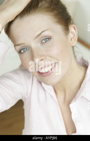 A blonde woman smiles as she looks at the camera Stock Photo - Alamy