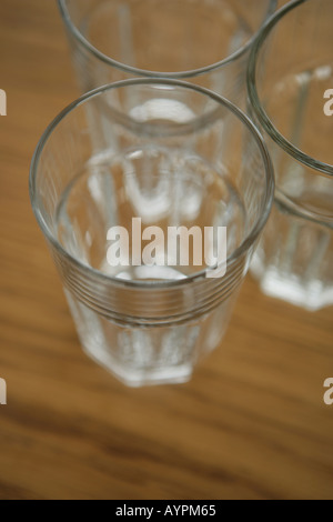 Three empty glasses kept on a table close to each other Stock Photo