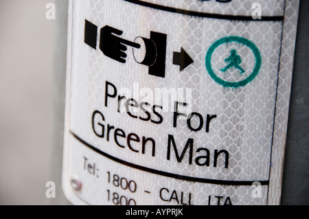 press for green man sign on traffic pole Stock Photo