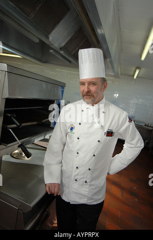 Dave Trevena Lecturer in Hospitality and Tourism at Cornwall College Camborne standing wearing a chefs uniform Stock Photo
