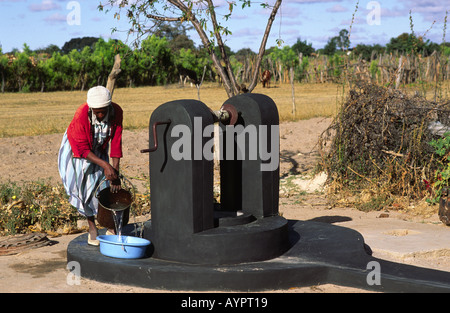 Woman using the new improved village tube-well in rural Zimbabwe Stock Photo