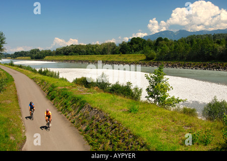 Cyclists in the Rhine River Valley, view from the left bank (Swiss side) toward Liechtenstein on the right bank Stock Photo