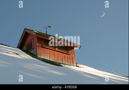 The cupola and weather vane on the roof of an historic old red barn Stock Photo