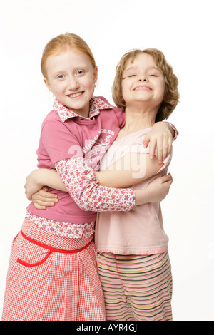 Two eight-year-old girls hugging Stock Photo