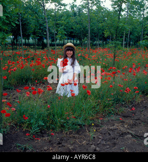 girl in poppy field. Photo by Willy Matheisl Stock Photo