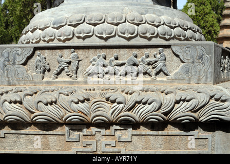 Bas relief of training for martial arts on pagoda at pagoda forest stupa at Shaolin Buddhist Monastery Temple Henan Province Stock Photo