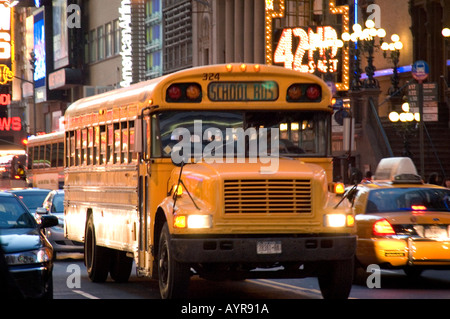 OLD SCHOOL BUS PASSING THROUGH 42ND STREET THEATER DISTRICT