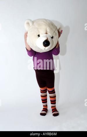 Four year old girl with the head of a polar bear Stock Photo